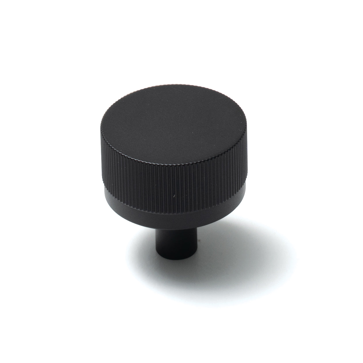 Momo Bellevue lined cabinet knob with a sleek design, featuring a polished metal finish, mounted on a wooden cabinet door.