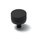 Momo Bellevue lined cabinet knob with a sleek design, featuring a polished metal finish, mounted on a wooden cabinet door.