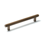 Momo Bellevue lined cabinet pull handle in bronze finish, showing a close-up view of the stylish, curved hardware for furniture drawers.