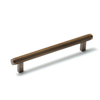 Momo Bellevue lined cabinet pull handle in bronze finish, showing a close-up view of the stylish, curved hardware for furniture drawers.
