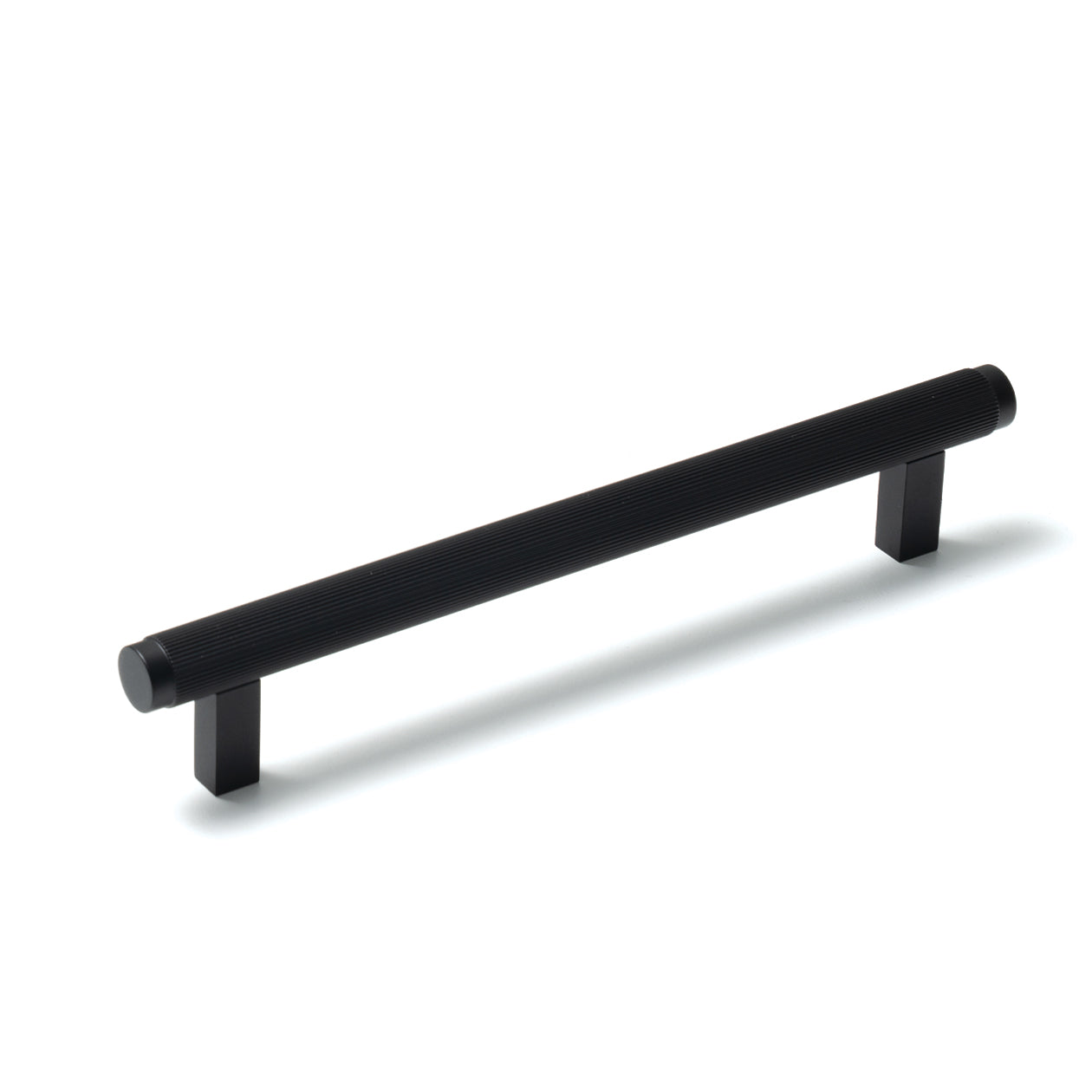 Momo Bellevue lined cabinet pull handle in matte black finish, mounted on a wooden cabinet door.