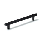 Momo Bellevue lined cabinet pull handle in matte black finish, mounted on a wooden cabinet door.