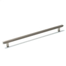 Momo Bellevue lined cabinet pull handle in dark bronze finish mounted on a cabinet door.