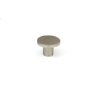 Momo COMO cabinet knob in brown finish with a rounded design, mounted on a wooden cabinet door.
