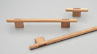 Kethy L7819 Koge timber cabinet pull handle mounted on wooden cabinet door, featuring a sleek, modern design in natural wood finish.