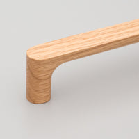 Kethy Timber Pinta timber cabinet pull in oak finish with sleek, modern design for kitchen or bathroom cabinetry.