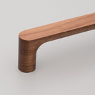 Kethy Timber Pinta timber cabinet pull in warm wood finish, featuring a sleek, modern design for kitchen or bathroom cabinetry.