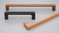 Kethy Timber Pinta timber cabinet pull in dark brown finish, mounted on a cabinet door, showcasing modern hardware design.