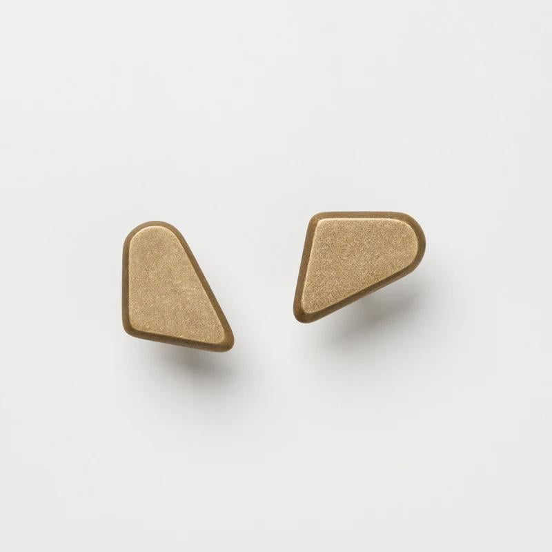 Lo & Co Interiors Outline Knobl cabinet handle, left or right, in a sleek brushed finish, mounted on a modern furniture piece.
