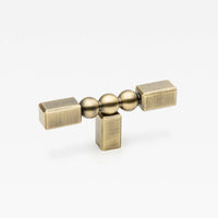Small Lo & Co ORBE cabinet T-pull handle with sleek brass finish, designed for modern furniture cabinets.