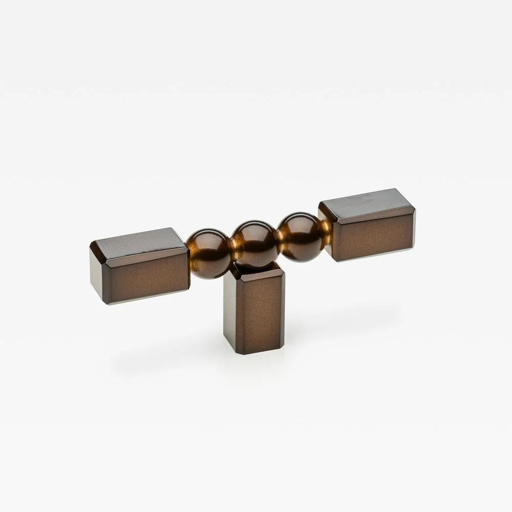 Small Lo & Co ORBE cabinet T-pull handle in brushed bronze finish, designed for modern furniture cabinets.