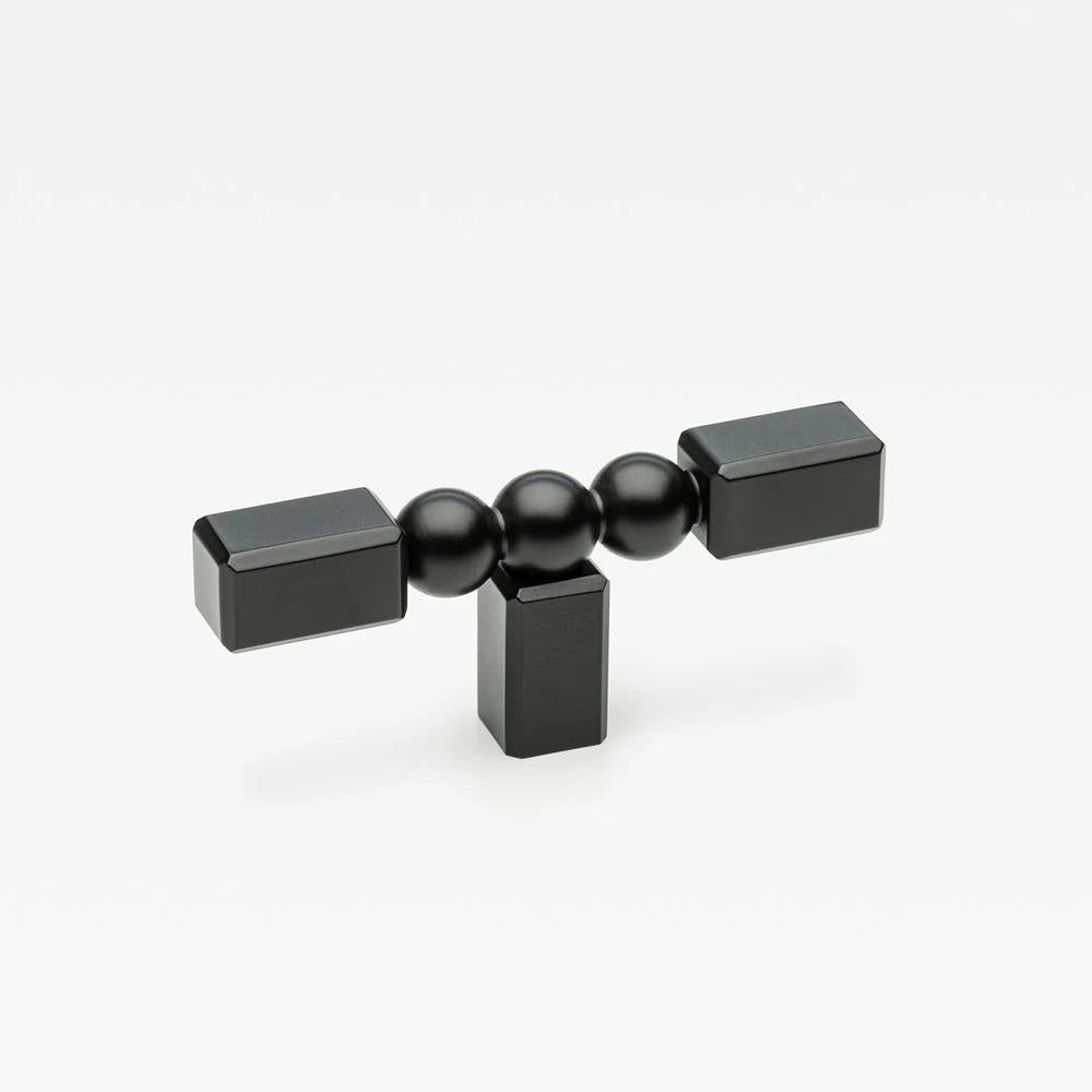 Small Lo & Co ORBE Cabinet T-Pull handle in brushed nickel, showing its sleek, modern design mounted on a cabinet door.