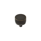 Momo BELLEVUE knurled cabinet knob in dark bronze finish mounted on wood cabinet door.