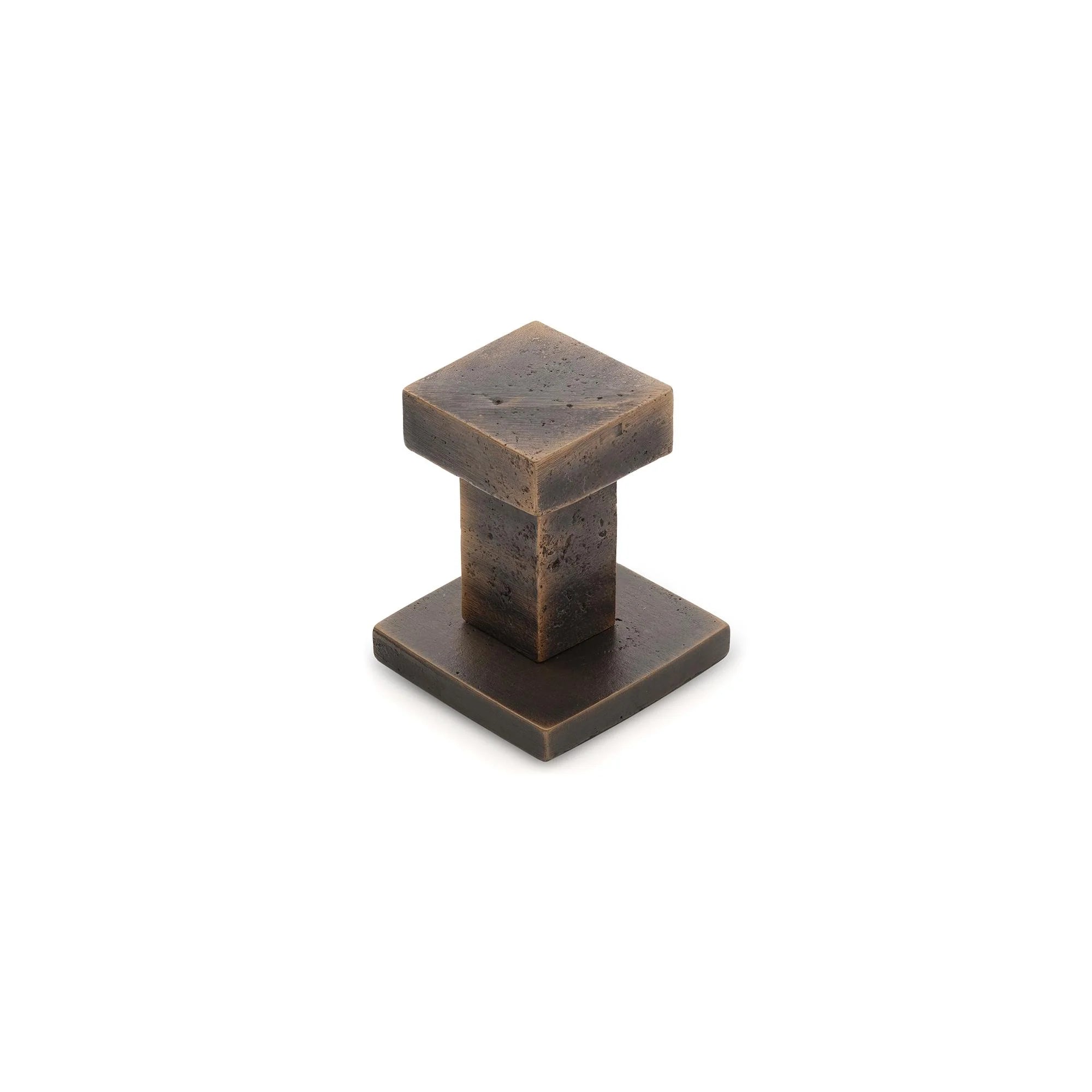 Castella Cast Square Wall Hook mounted on a wall, showing its sleek black metal design for hanging items.