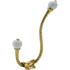 Tradco porcelain tip rope hat and coat hook mounted on wall, vintage style with elegant porcelain tips and sturdy metal construction.