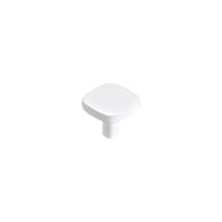Momo Porto cabinet knob in white ceramic with a rounded design, mounted on a wooden cabinet door.