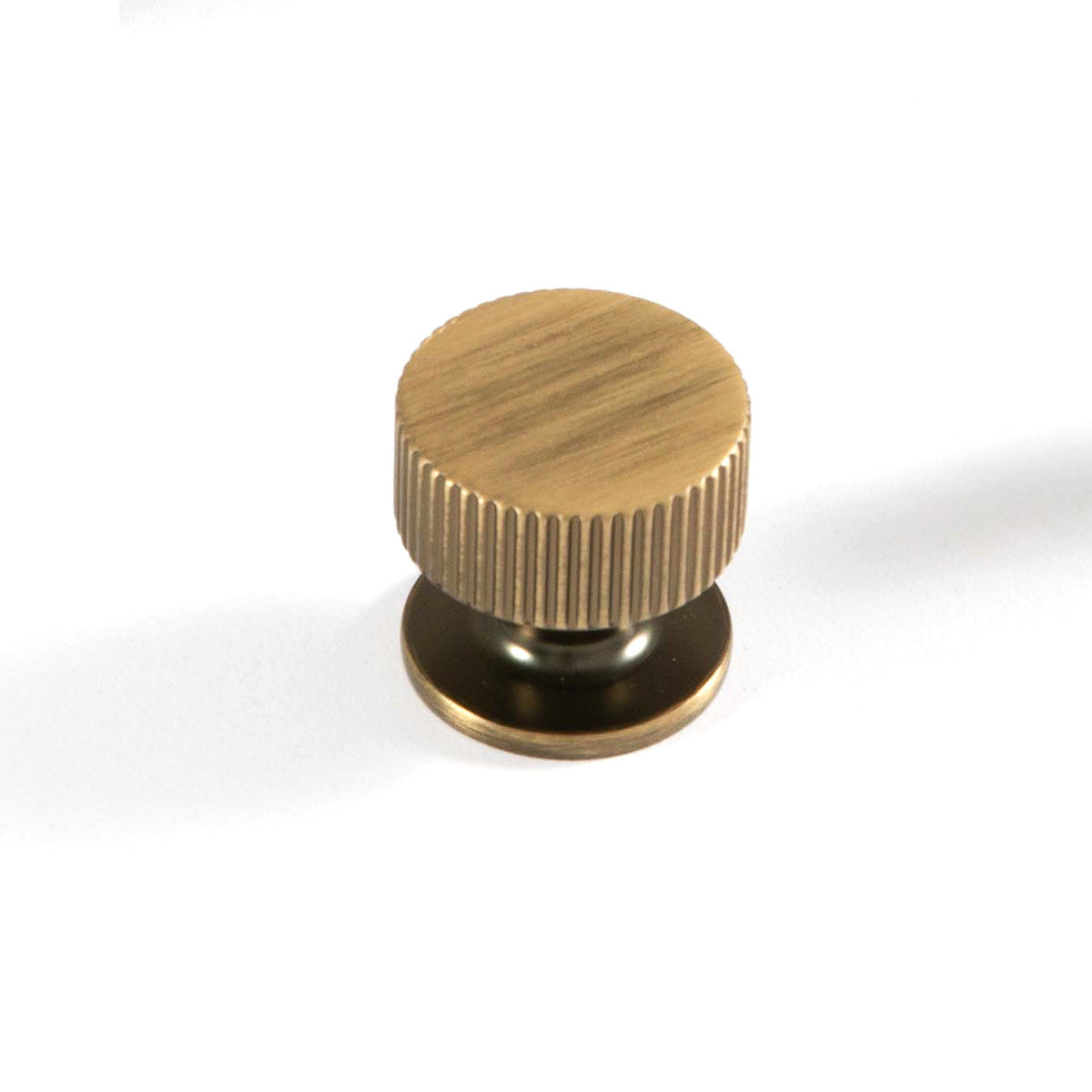 Momo Ambrose round cabinet knob with a sleek metallic finish, featuring a smooth, rounded design for modern furniture.