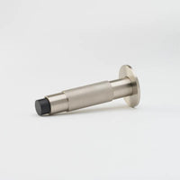 Lo & Co Interiors knurled Kintore doorstop in bronze finish, made of metal with textured knurled surface for door stability.