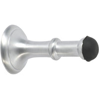 Tradco concealed fix door stop, 80mm length, with chrome finish, mounted on a door to prevent damage and hold doors open.