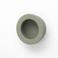 Round flush pull handle by Castella, 40mm diameter, with a sleek finish, designed for cabinet or furniture doors.