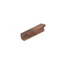 Momo FLAPP Timber Cabinet Pull Handle in WN finish mounted on a wooden cabinet door