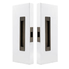 Windsor LUME sliding door flush pull passage set with two orange flush pulls on a door, modern hardware for sliding doors.
