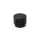 Momo GRAF cabinet knob in black with sleek modern design, mounted on a wooden cabinet door.