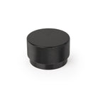 Momo GRAF Cabinet Knob in matte black finish, modern round design, mounted on a wooden cabinet door.