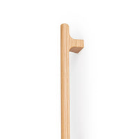 Momo HINOKI Big D timber cabinet pull handle in oak wood with a natural finish, mounted on a cabinet door.
