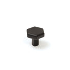 Momo Hendrix cabinet knob in black finish with a sleek, modern design, mounted on a wooden cabinet door.