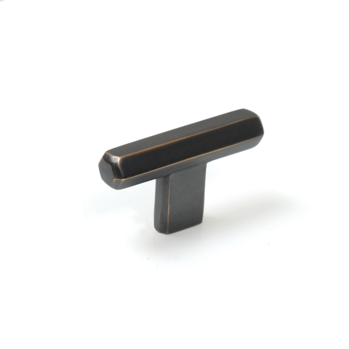 Momo Hendrix cabinet T-pull handle in antique brass finish, sleek design visible on a modern wooden cabinet door.