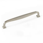 Brass Momo JAGO cabinet pull handle with a sleek, curved design mounted on wood cabinet door.