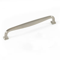 Brass Momo JAGO cabinet pull handle with a sleek, curved design mounted on wood cabinet door.
