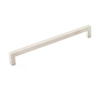 Momo SEVILLA cabinet pull handle in antique bronze finish with curved design, mounted on a wooden cabinet.