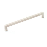 Momo SEVILLA cabinet pull handle in antique bronze finish with curved design, mounted on a wooden cabinet.