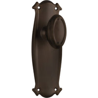 Pair of Tradco Bungalow Knobs on long backplates, showing vintage-style brass door hardware with ornate detailing.