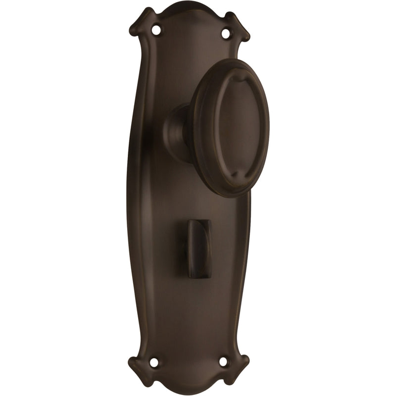 Pair of Tradco Bungalow Knobs on long backplates, vintage-style door hardware with decorative brass finish.