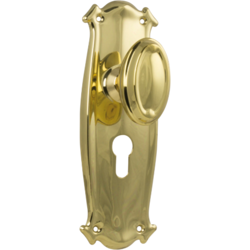 Pair of Tradco Bungalow Knobs with long backplates, featuring vintage-style brass finish and decorative design.