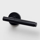 Lo & Co Kintore knurled lever handle on a door, featuring a sleek metal finish and textured grip for modern interior design.
