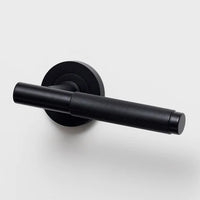 Lo & Co Kintore knurled lever handle on a door, featuring a sleek metal finish and textured grip for modern interior design.