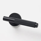 Lo & Co Linear Knurled Lever door handle in brushed metal finish, showing textured grip and sleek modern design.