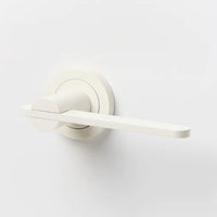 Lo & Co Intersect Lever door handle in polished metal with a sleek, modern design, mounted on a door.