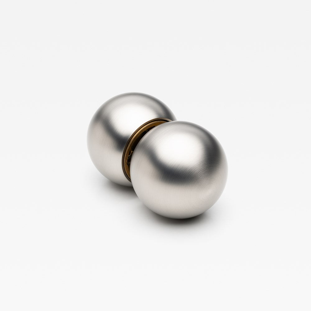 Lo & Co Interiors Sphere Passage Set featuring elegant brass door hardware with spherical design elements.