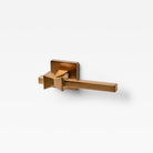 Lo & Co Forma Lever door handle in bronze finish with sleek modern design, mounted on a door.