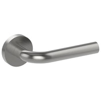 Stainless steel CAPRI door handle by Style Finish Doorware mounted on a door with a sleek, modern design.
