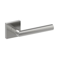 Stainless steel CETINA door handle by Style Finish Doorware installed on a door, featuring a sleek modern design.