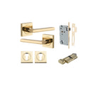 Pair of Iver Baltimore lever handles on square rose, polished brass finish, mounted on door with keyhole and modern design.