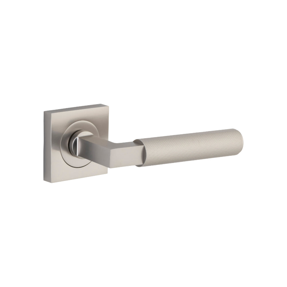 Pair of Iver Brunswick lever door handles on square rose, featuring a polished metal finish and modern design.
