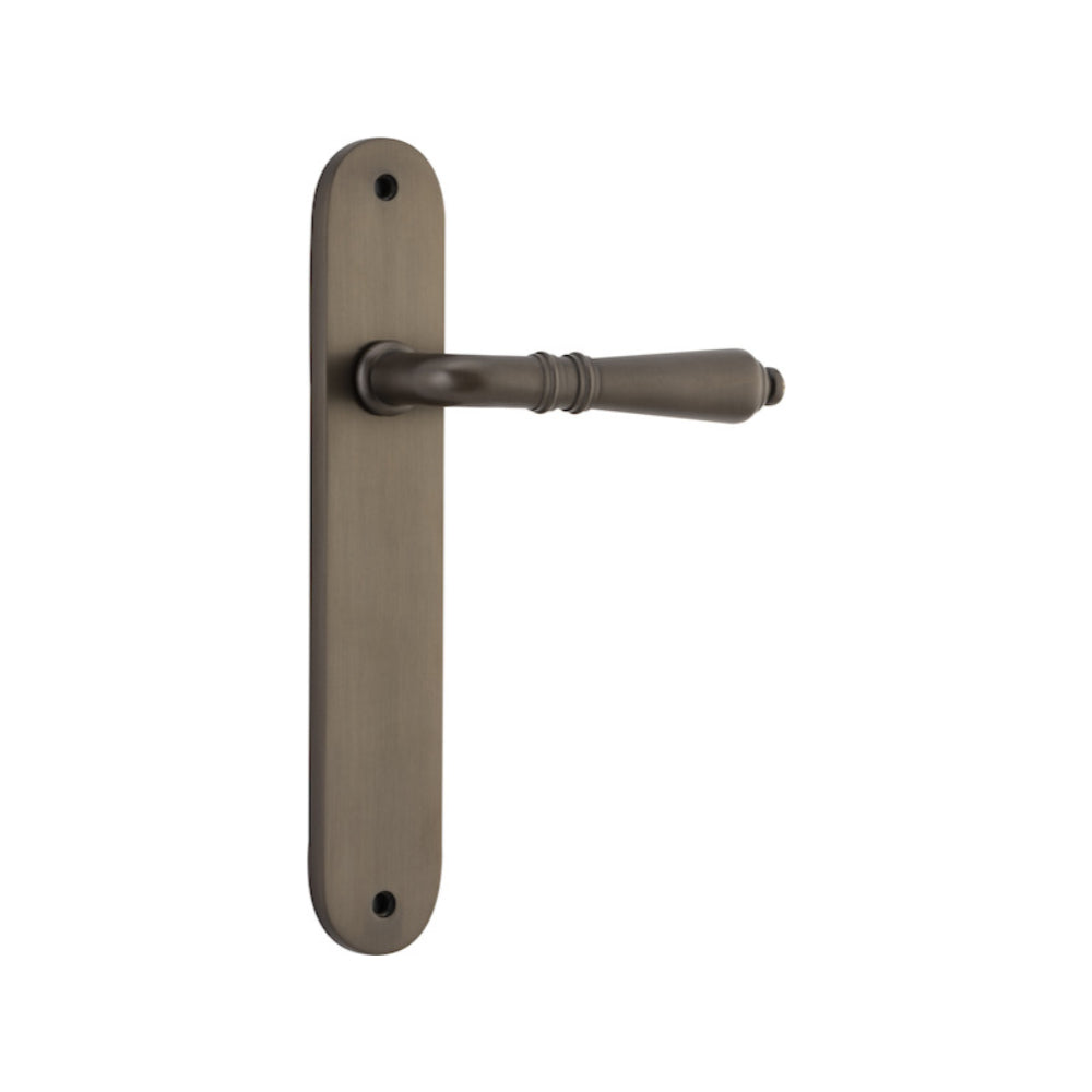 Pair of Iver Sarlat lever door handles on oval backplates, featuring elegant design and polished finish.