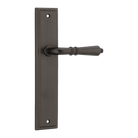 Pair of Iver Sarlat lever handles on stepped backplates, showcasing elegant brass finish and classic European design.